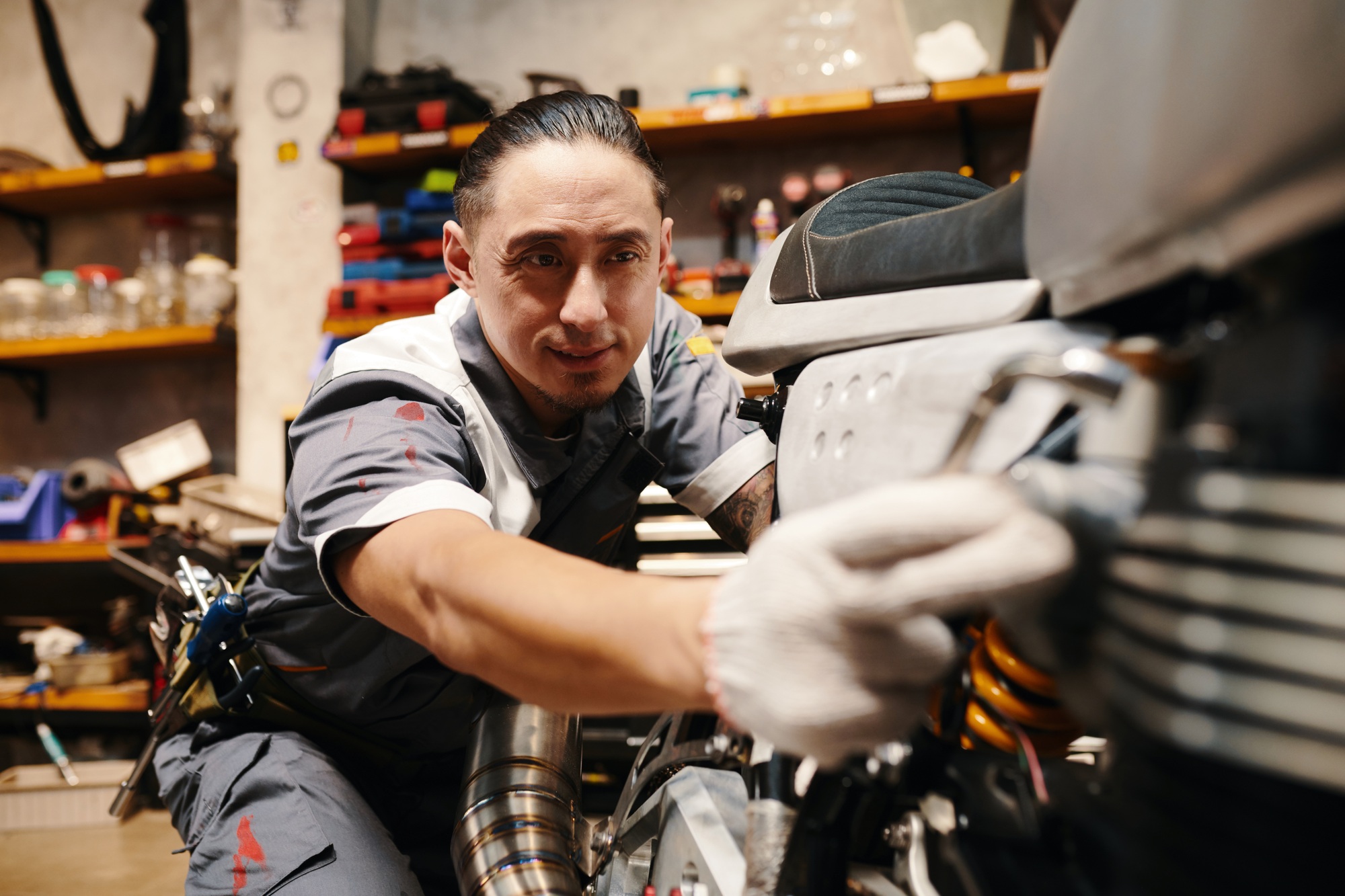 Mechanic Repairing Motorbike in Garage